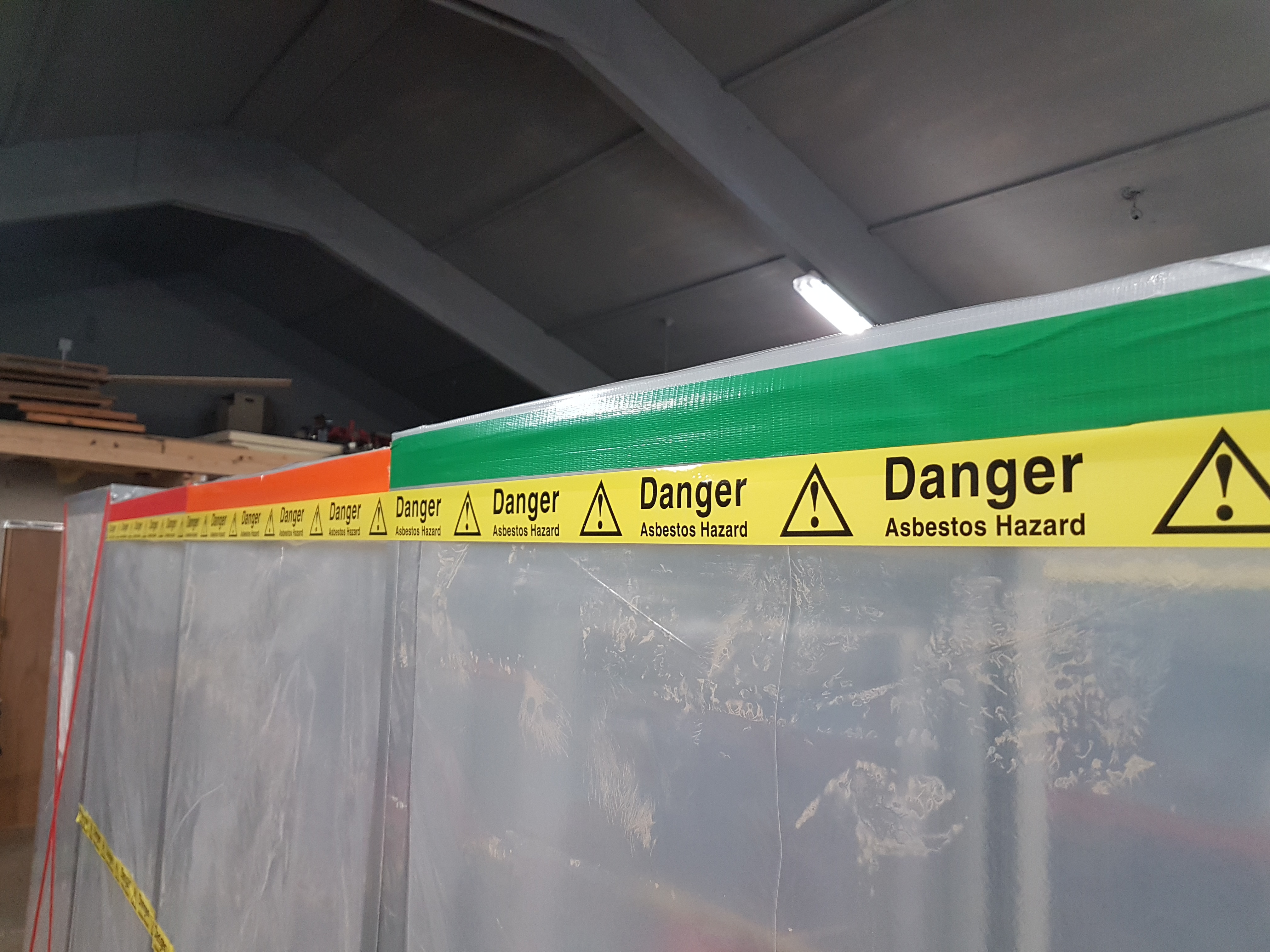 A closeup of asbestos warning tape