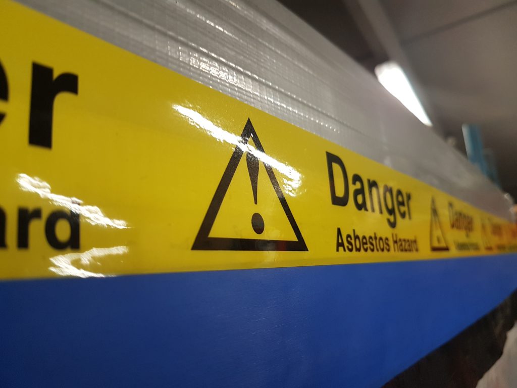 A closeup of asbestos warning tape